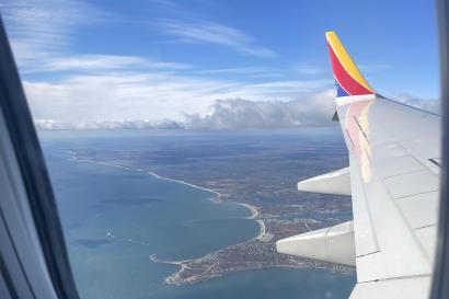 A plane wing over an ocean