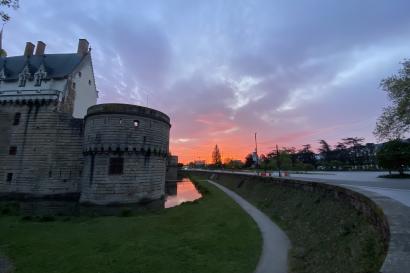 A castle turret illuminated by a sunrise. 