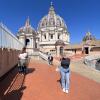 Girl standing on top of Vatican dome.
