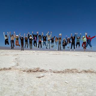 students jumping in a line in Jujuy salt flats