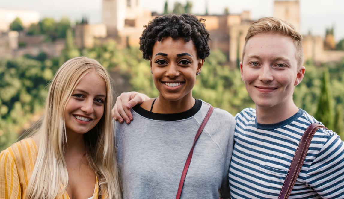 students pose for a photo in front of Alhambra Palace in Granda
