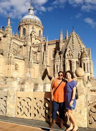 two students pose for a photo in front of the New Cathedral of Salamanca