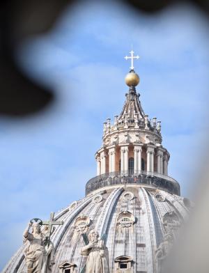 a cross atop a dome at the Vatican