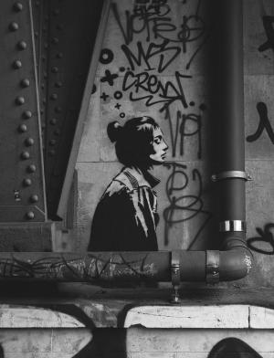 A wall with graffiti and the painting of a woman in Berlin, Germany.