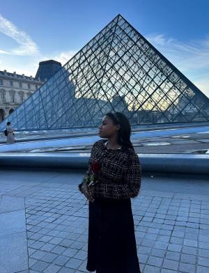 Student in front of Louvre Pyramid in Paris, France
