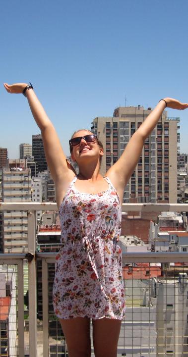 a student poses for a fun photo at the top of a building in Buenos Aires