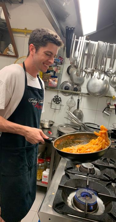 a student intern making pasta in a kitchen