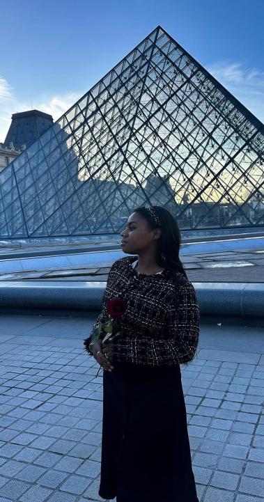 Student in front of Louvre Pyramid in Paris, France
